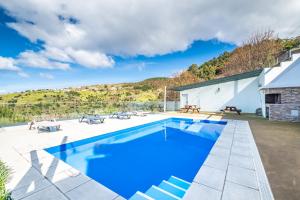 a swimming pool in the backyard of a house at Ocean Panorama Apartments by Madeira Sun Travel in Calheta