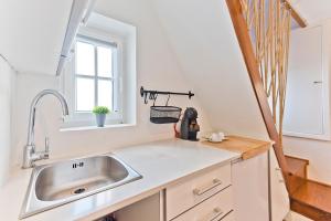a kitchen with a sink and a window at BmyGuest - Fado Mezzanine Apartment in Lisbon