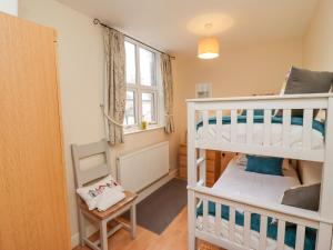 a bedroom with two bunk beds and a window at White Horses in Whitby