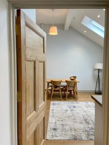 an open door to a dining room with a table at 19a Brooks Road in Street