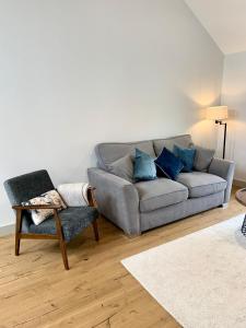 a living room with a couch and a chair at 19a Brooks Road in Street