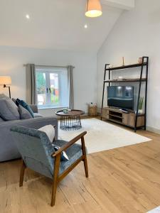 a living room with a couch and a tv at 19a Brooks Road in Street