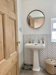 a bathroom with a sink and a mirror at 19a Brooks Road in Street