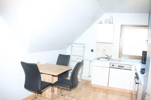 a kitchen with a wooden table and chairs at Ferienwohnung 1 Jöbstl 