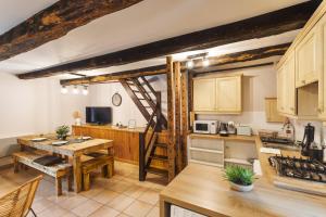 a kitchen with a table and a dining room at Les Petits Matelots - Maison proche plage in Saint-Coulomb +10 photos