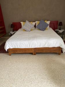 a bed with four pillows on it in a room at Home Sweet Home in St. Julianʼs