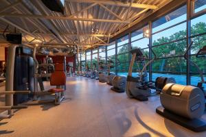 a gym with a row of treadmills and machines at Dorint Hotel & Sportresort Arnsberg/Sauerland in Neheim-Hüsten