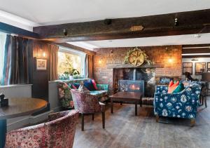 a living room with chairs and a fireplace at The Mill Hotel in Sudbury