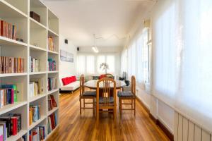 a dining room with a table and bookshelves at Ybarra apartment by People Rentals in Bilbao