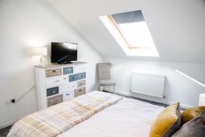a bedroom with a bed with a tv on top at 'Hidden Jewel' city centre + FREE PARKING in Plymouth