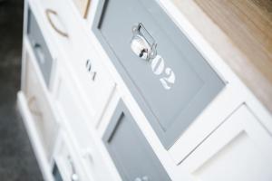 a white drawer with a door with a handle at 'Hidden Jewel' city centre + FREE PARKING in Plymouth