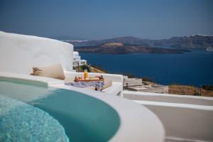 a view of a swimming pool and the ocean at Akrorama private villas and suites in Akrotiri