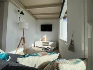a white room with two beds and a window at Loft en zona rural de Lanzarote in Conil
