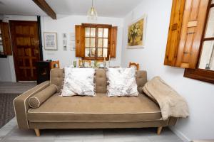un sofá en una sala de estar con almohadas en Casa Poulo Padrón en Padrón