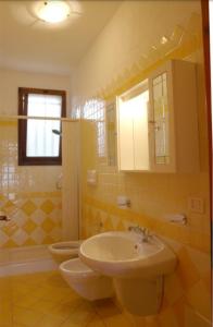 een badkamer met een wastafel en een toilet bij Primavera Apartments in Capo Testa