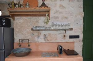 a kitchen with a bowl on top of a counter at Casa Muse Kastellorizo in Meyisti
