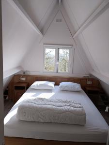 デュルビュイにあるSunclass Durbuy huisje 39の窓付きの客室の白いベッド1台