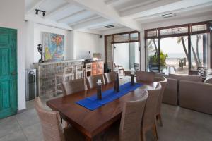 a dining room with a wooden table and chairs at Hikks Villa in Hikkaduwa