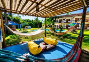 a hammock in a resort with a playground at Pousada Casarão de Itaúnas in Itaúnas