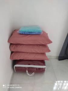 a stack of blankets sitting on top of a floor at R&R HOMESTAY in Simpang Renggam