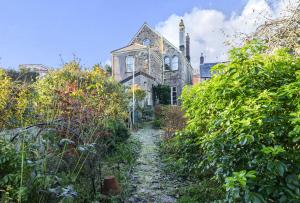 an old house with a garden path in front of it at Roscrea Bed & Breakfast in Bodmin