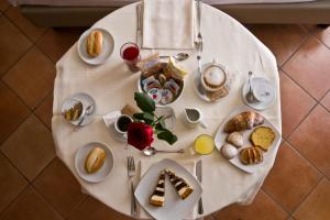 a white table with plates of food on it at Hotel Nuvò in Naples