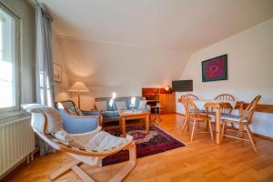 a living room with a couch and a table and chairs at Hotel Zur Eule in Oldenburg in Holstein