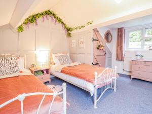a bedroom with two beds and a window at Bodlondeb in Porthmadog