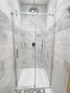 a shower with a glass door in a bathroom at Ubytování v soukromí s bazénem Tři Splavy in Čeladná
