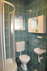 a bathroom with a toilet and a sink at Apartment with parking in the free garage in Sarajevo