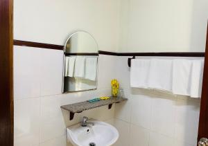 a white bathroom with a sink and a mirror at Khách sạn Sao Mai in Ben Tre +18 photos