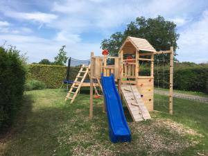 a wooden playset with a slide and a ladder at Austernfischer - Haus 12 in Lenste