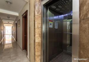 a hallway with a glass elevator in a building at MURAT 2 Hotel in Kemer