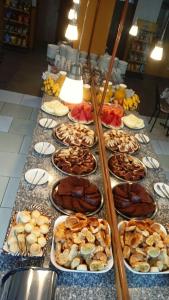 a buffet with many plates of food on a table at Hotel São Francsico de Ibitinga in Ibitinga