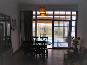 a dining room with a table and a large window at Quinta De Azemeis in Vimieiro