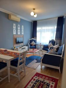 a living room with a couch and a table at Emirhan Guesthouse & Suites in Istanbul