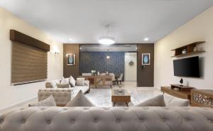 a living room with two couches and a tv at BKT Cribs - Apartments & Suites in Abuja