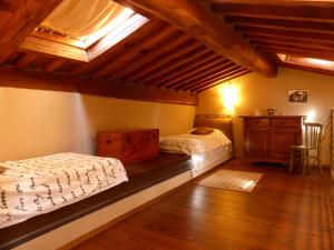 a bedroom with two beds and a dresser in a attic at La Celata in Lucca
