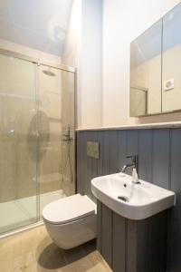 a bathroom with a sink and a toilet and a shower at Alde Bay Farm - Coral Cottage in Aldeburgh