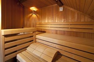 a wooden sauna with two wooden benches in it at Hotel Angerbräu in Murnau am Staffelsee