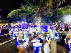 a wedding reception on the beach at night at Tamala Beach Resort in Kotu