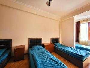 a room with two beds and a window at ArevaHostel&Apartment in Yerevan