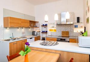 a kitchen with wooden cabinets and a white counter top at Ferienwohnung ALEX in Burgau