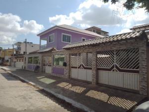 ein Haus mit einem Zaun an der Straßenseite in der Unterkunft Casa e área Gourmet. Cardoso Moreira-RJ in Cardoso Moreira