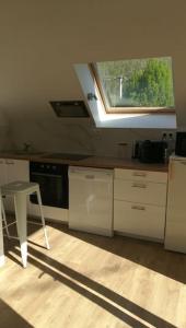 a kitchen with a window and a table and a stool at le beau coin, unique et magique 