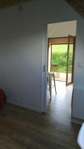 an empty living room with a door and a table at le beau coin, unique et magique 