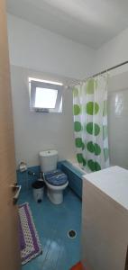 a bathroom with a toilet and a shower curtain at Margaret's Guest House in Mesopotam +27 photos