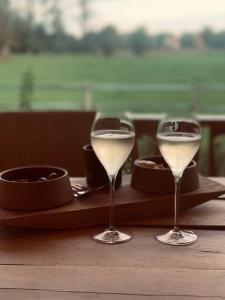 two glasses of white wine sitting on a table at Huis van luut in Tielt