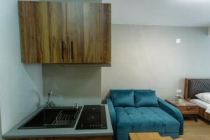 a living room with a couch and a kitchen at Didveli Gallery B-110 in Bakuriani
