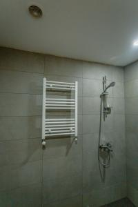 a bathroom with a shower with a window at Didveli Gallery B-110 in Bakuriani